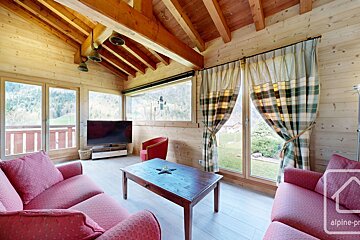 A living room with a couch and a coffee table and a sign that says alpine-pro