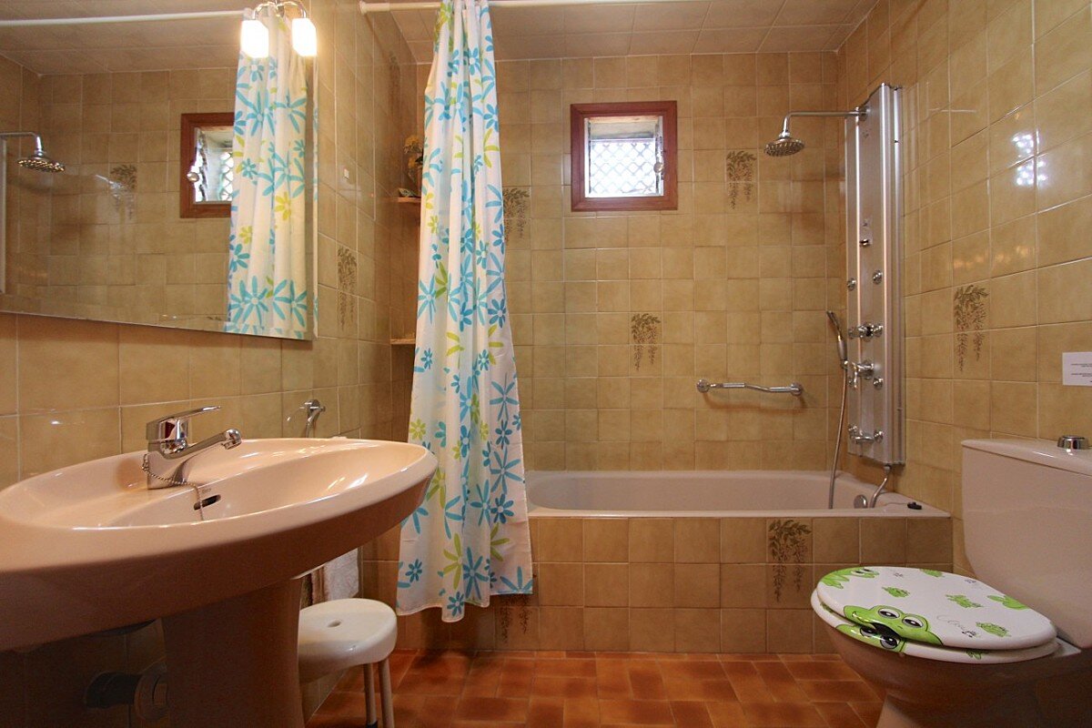 A bathroom with a sink a toilet and a bathtub