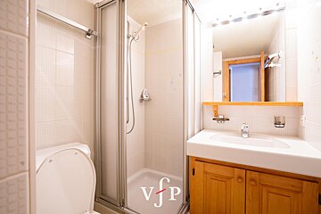 A bathroom with a toilet a sink and a shower with vfp written on the bottom