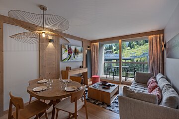 A living room with a painting of a skier on the wall
