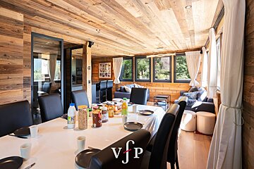 A dining room table with a vjp logo on it