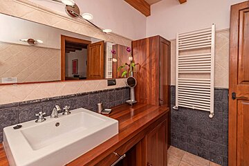 A bathroom with a sink and a towel rack