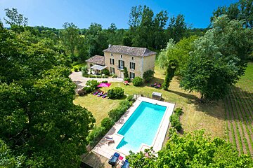 A large house with a large pool in front of it