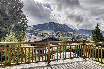A balcony with a view of the mountains and a sign that says knight frank