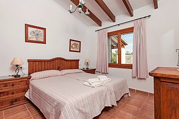 A bedroom with a large bed and two nightstands