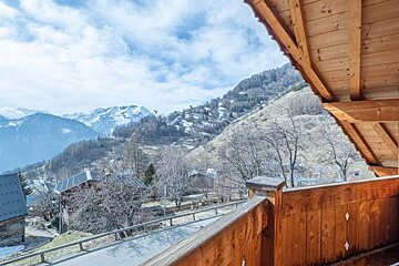 A balcony with a view of a snowy mountain range