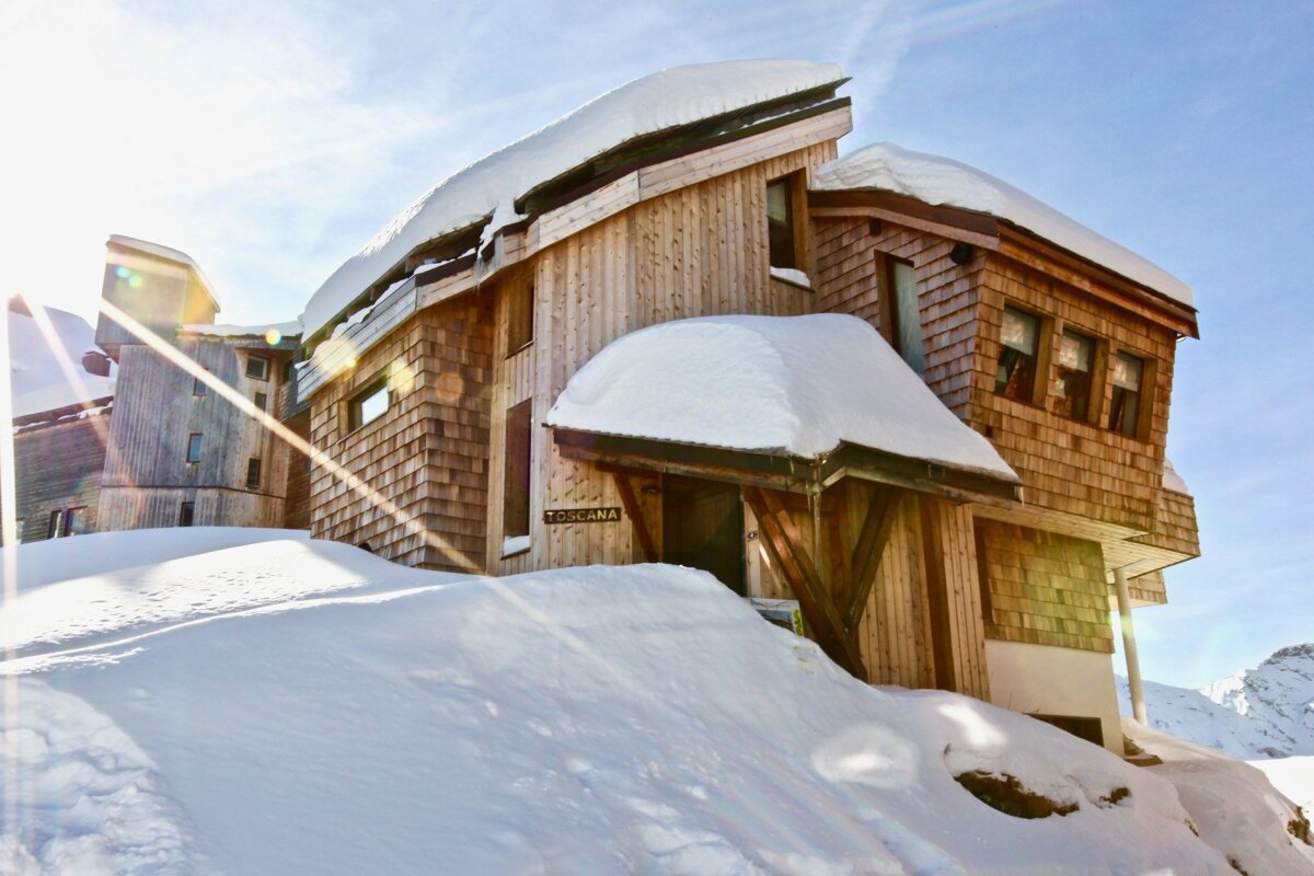A snow-covered wooden lodge, 