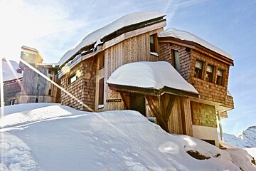 A snow-covered wooden lodge, 