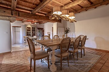A dining room with a table and chairs and the word immobilier on the wall