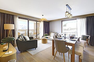A living room with a dining table and chairs