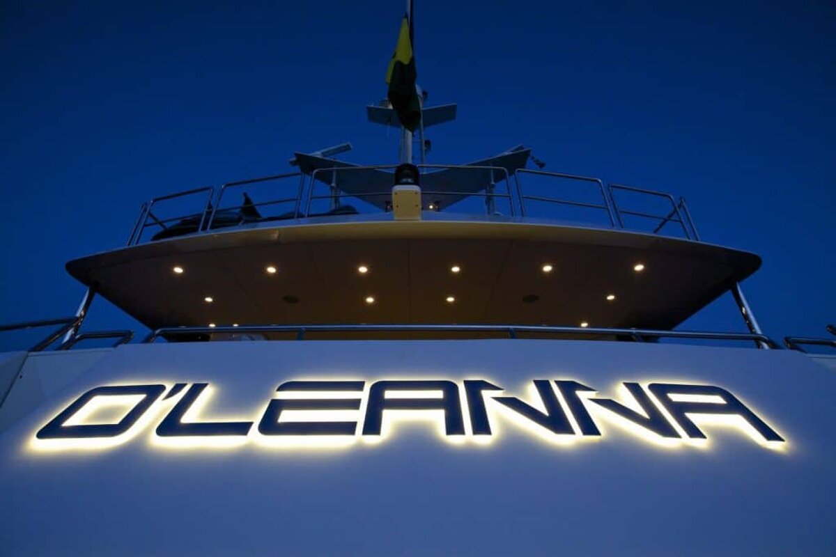 The name oleanna is lit up on the side of a boat