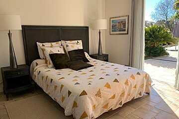 A bedroom with a bed and a picture on the wall