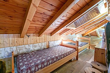 A bedroom with two beds and a snowboard hanging on the wall
