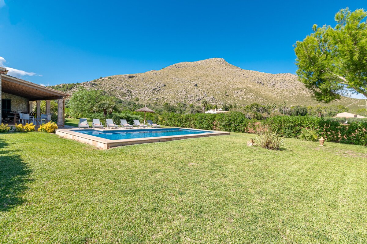 A large swimming pool with a mountain in the background