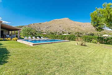 A large swimming pool with a mountain in the background