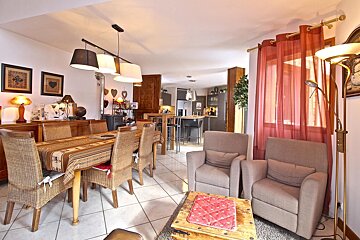 A living room with a dining table and chairs
