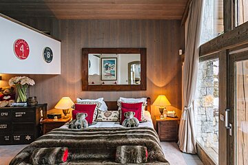 A bedroom with a bed and a nightstand with the number 4 on it