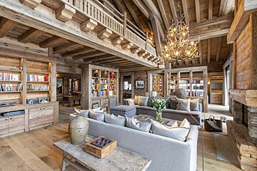 A living room with a couch and a chandelier