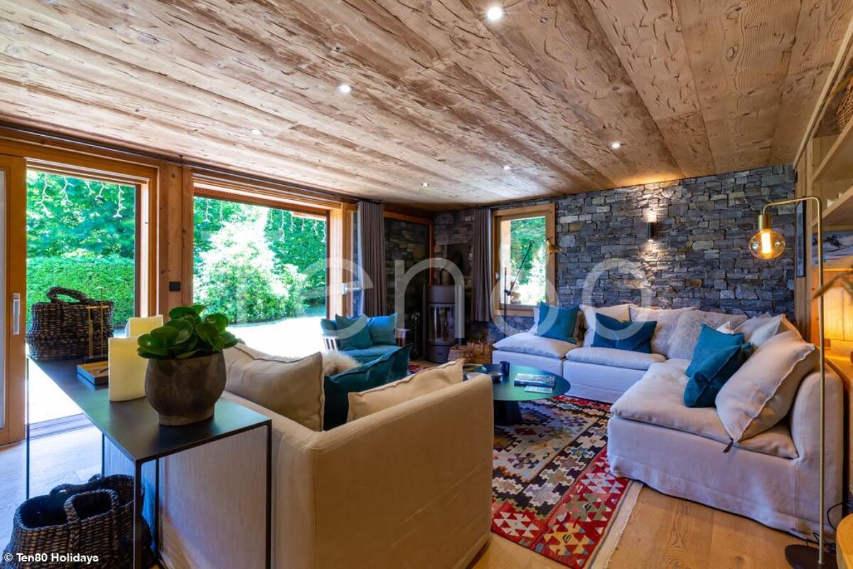 A living room with a couch and a rug and a sign that says ten80 holidays