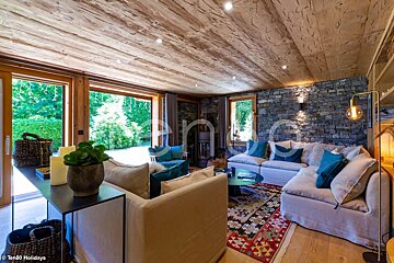 A living room with a couch and a rug and a sign that says ten80 holidays