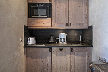 A small kitchen with a toaster and coffee maker
