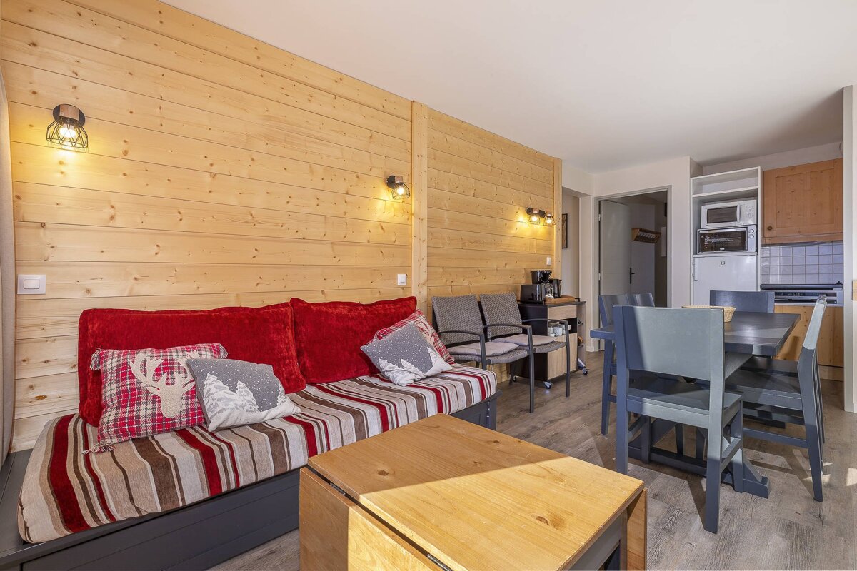 A living room with a couch and a table and chairs
