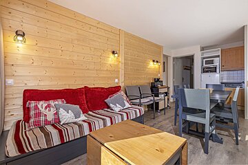 A living room with a couch and a table and chairs