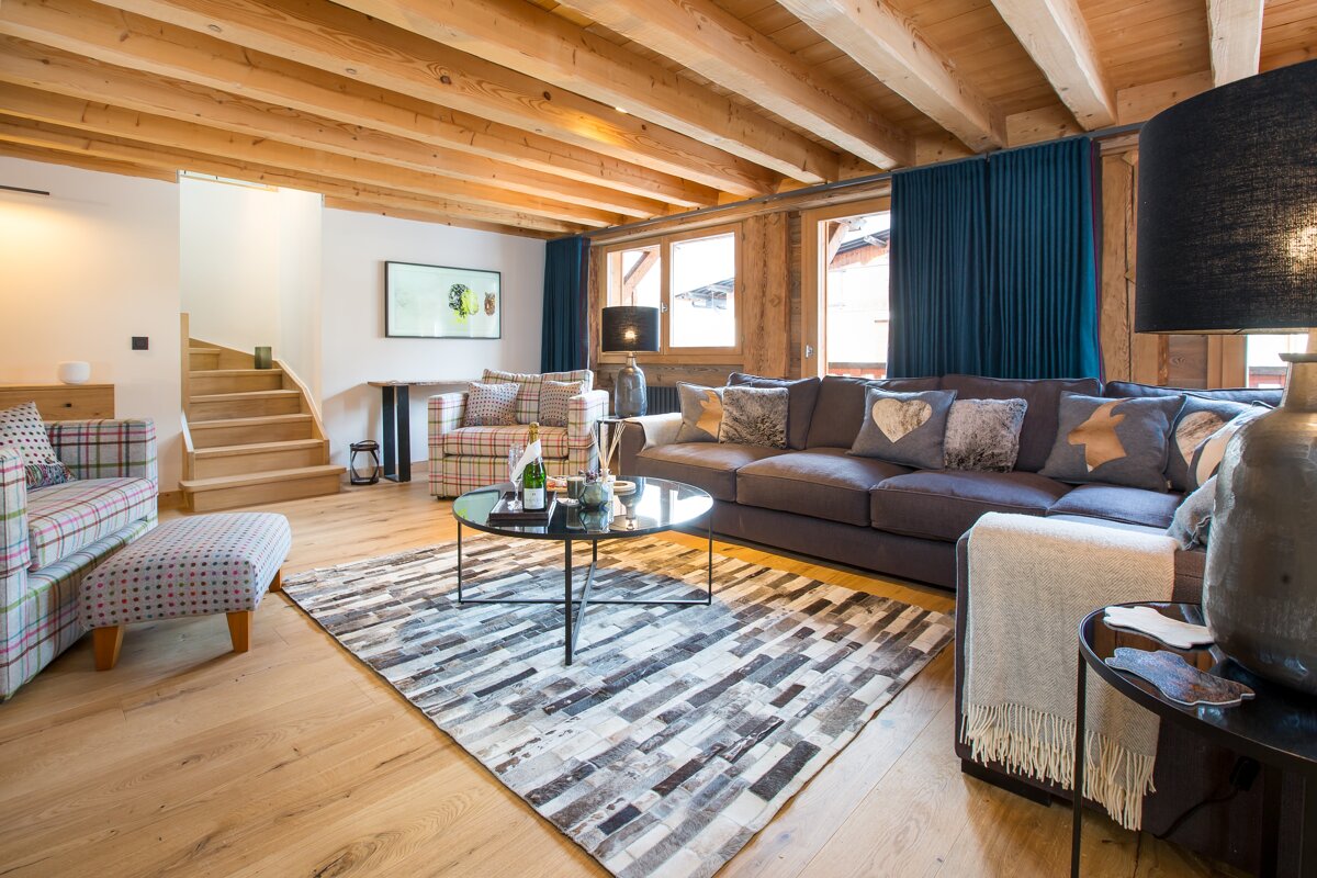 A living room with a couch and a rug