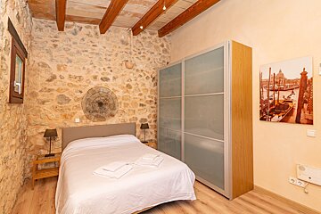 A bedroom with a picture of boats on the wall