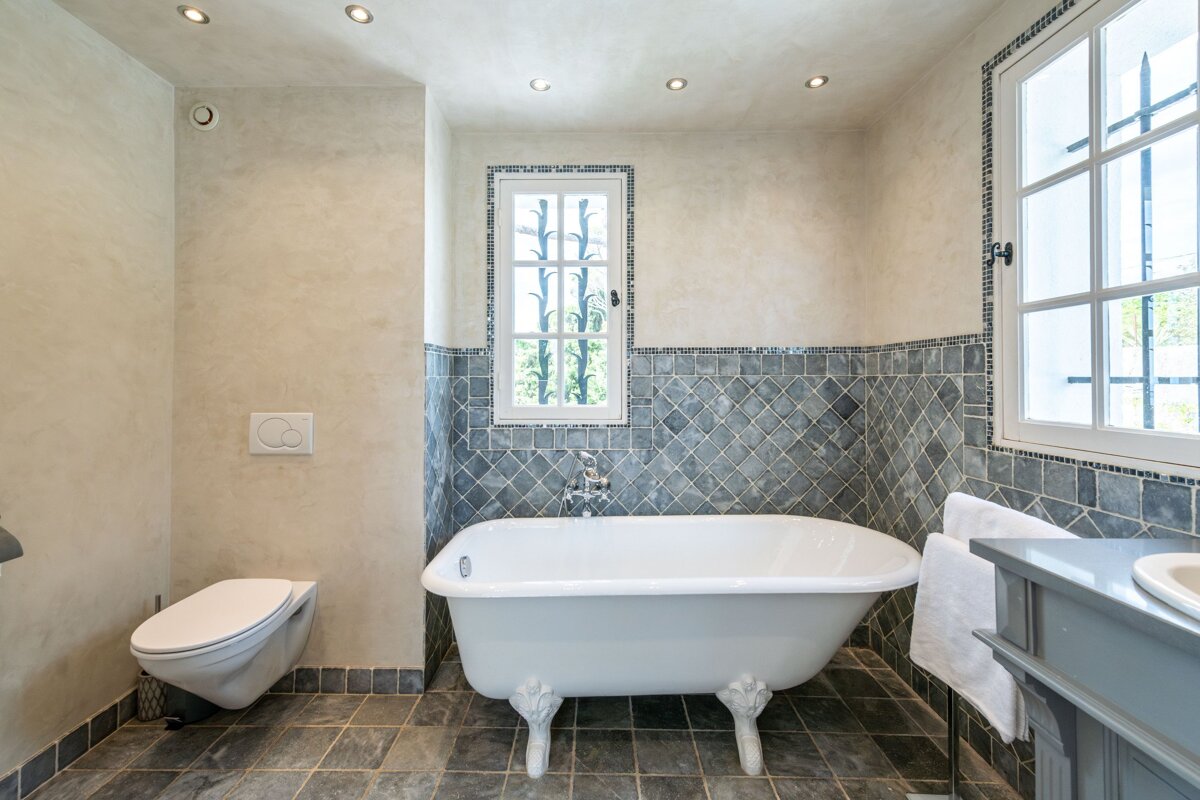 A bathroom with a claw foot tub and a toilet