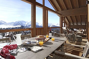 A table with a bottle of wine and a pitcher of orange juice