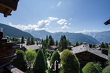 A view of the mountains from a balcony with nfp written on the bottom