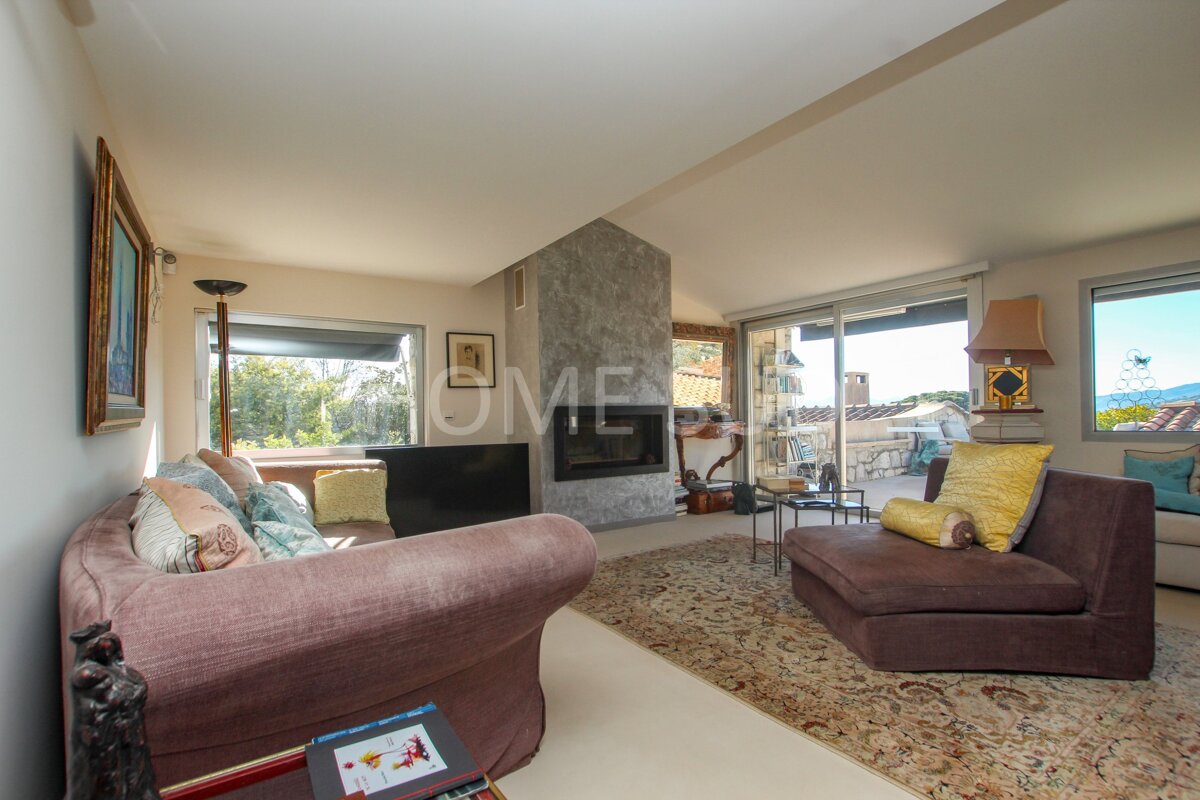 A living room with a fireplace and a sign that says home