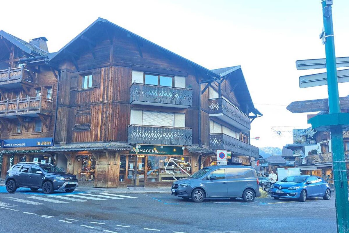 A wooden house with stairs leading up to it