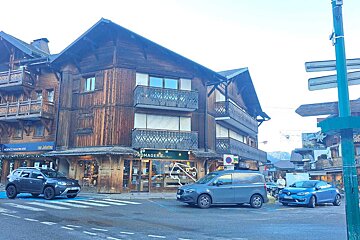A wooden house with stairs leading up to it