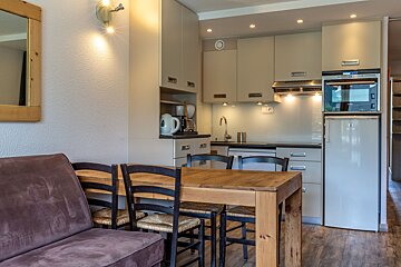 The sun is shining brightly over the snowy mountains