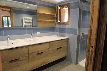 A bathroom with two sinks and a window