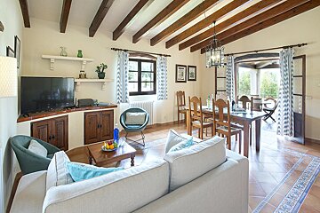 A living room with a white couch and a flat screen tv