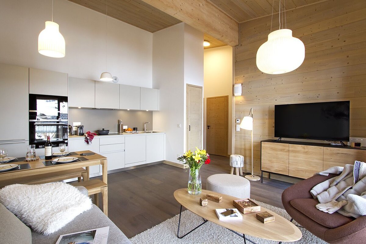 A living room with a couch a table and a television