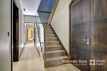 A hallway with a staircase and the words mountain base on the wall
