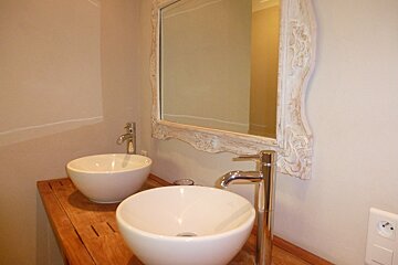 A bathroom with two sinks and a mirror