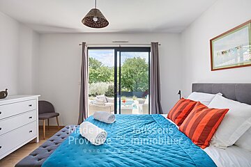 A bedroom with a bed and a dresser that says made in provence