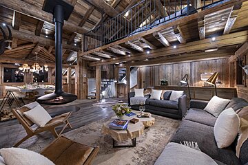 A living room with a couch and a table with a book on it