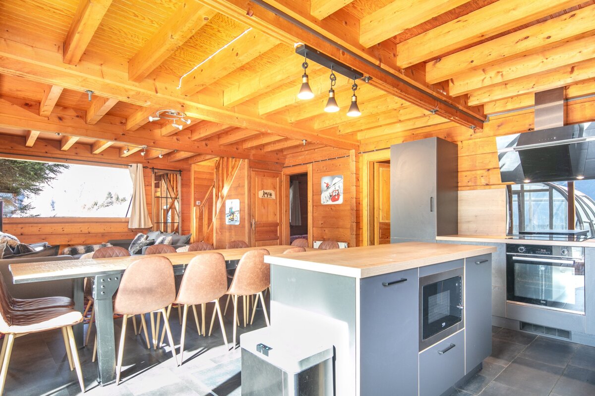 A kitchen with a table and chairs and a sign that says ' a ' on it
