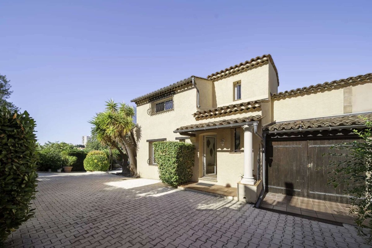 A house with a brick driveway leading to it