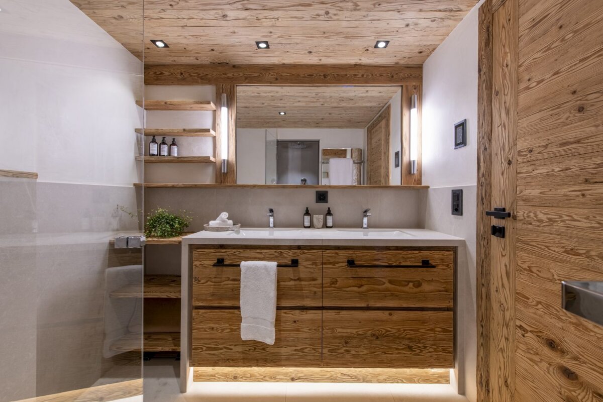 A bathroom with wooden cabinets and a sink