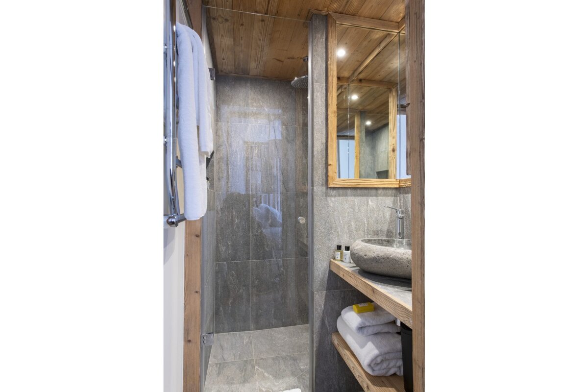 A bathroom with a sink and a walk in shower