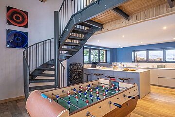 A spiral staircase leads to the second floor of a house