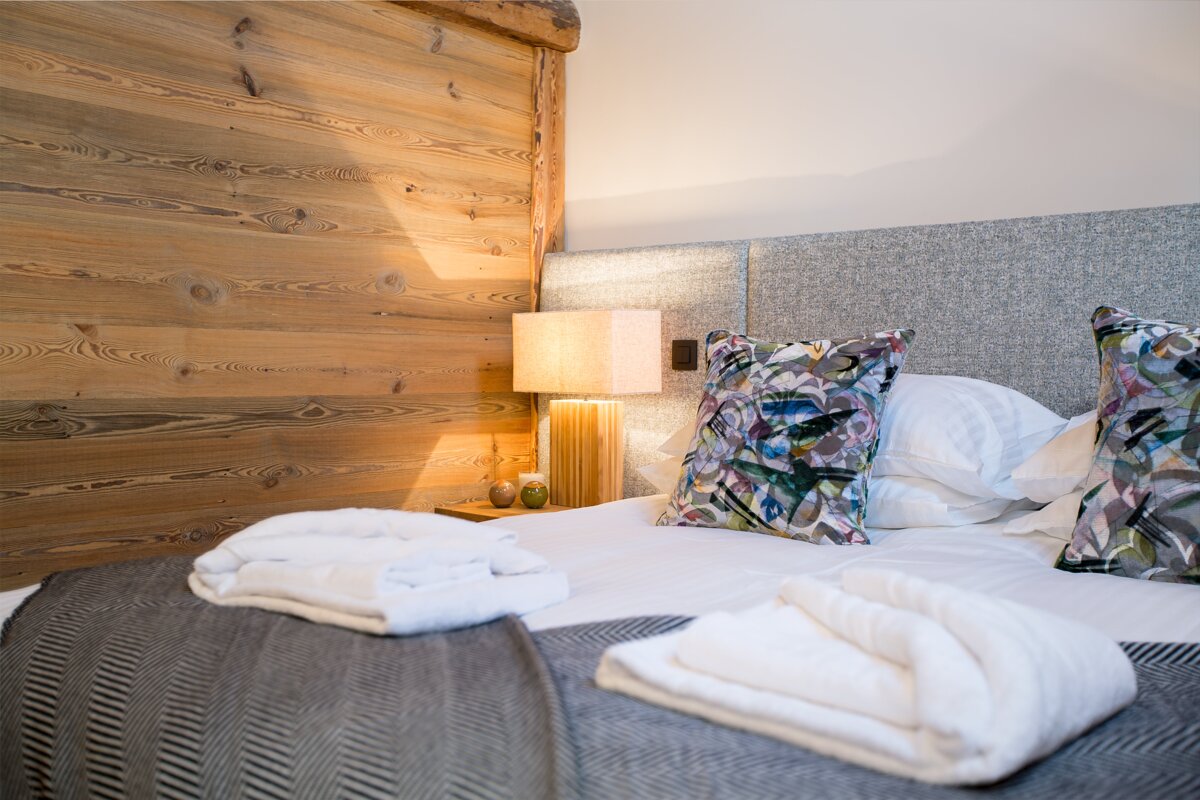 A bed with a lamp and pillows on it