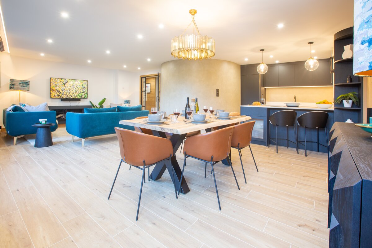 A living room with a dining table and chairs